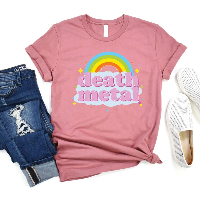 May include: A pink t-shirt with a rainbow and a cloud that says "death metal" in pink letters.