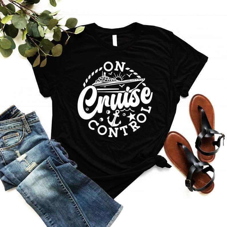 May include: Black t-shirt with a white graphic of a cruise ship and the text "On Cruise Control".