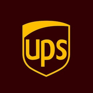 May include: The UPS logo features a gold shield shape with the letters "ups" in gold. The background is a dark brown color. The logo is a symbol of the United Parcel Service, a global package delivery company.