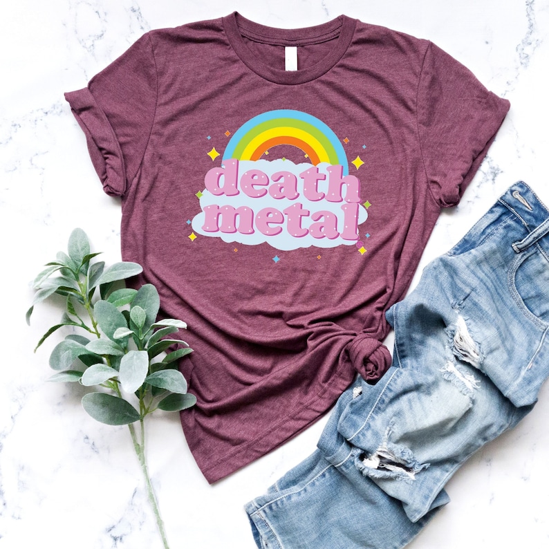 May include: A maroon t-shirt with a rainbow and the words "death metal" in pink letters on a blue cloud.