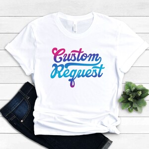 May include: White t-shirt with a gradient design that says "Custom Request" in a retro font.