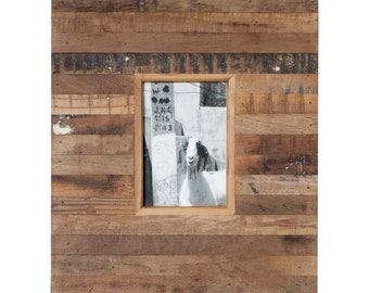 Könnte beinhalten: Ein rustikaler Holzbilderrahmen mit einer einzigen Öffnung für ein Foto. Der Rahmen ist aus recyceltem Holz mit einer natürlichen Oberfläche gefertigt. Das Foto im Inneren zeigt eine Ziege, die vor einer Backsteinmauer steht.