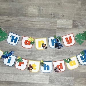 May include: A colorful "Happy Birthday" banner with jungle animal characters and green leaves. The letters are in different colors and each letter has a different animal character.