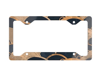 May include: A black and gold license plate frame with a repeating pattern of stylized waves.