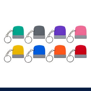 May include: A collection of eight rectangular keychains, each featuring a coloured top section and a grey base, attached to a silver metal split ring. The colours include teal, grey, purple, pink, yellow, blue, orange, and red, arranged in two rows.