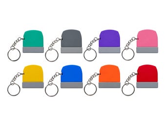 May include: A collection of eight rectangular keychains, each featuring a coloured top section and a grey base, attached to a silver metal split ring. The colours include teal, grey, purple, pink, yellow, blue, orange, and red.
