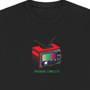 May include: Black t-shirt with a red and black television with a static screen and the text "PROGRAM COMPLETE" in green.
