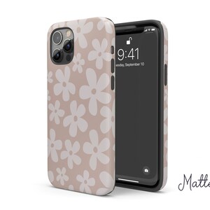 May include: A beige phone case with a white daisy pattern. The case is made of a matte material and has a clear back. The phone case is compatible with iPhone models.