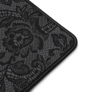 May include: A black and gray mousepad featuring a detailed lace pattern. The edges are finished with black stitching. The design is a close-up of the lace, showing the intricate floral and geometric details.