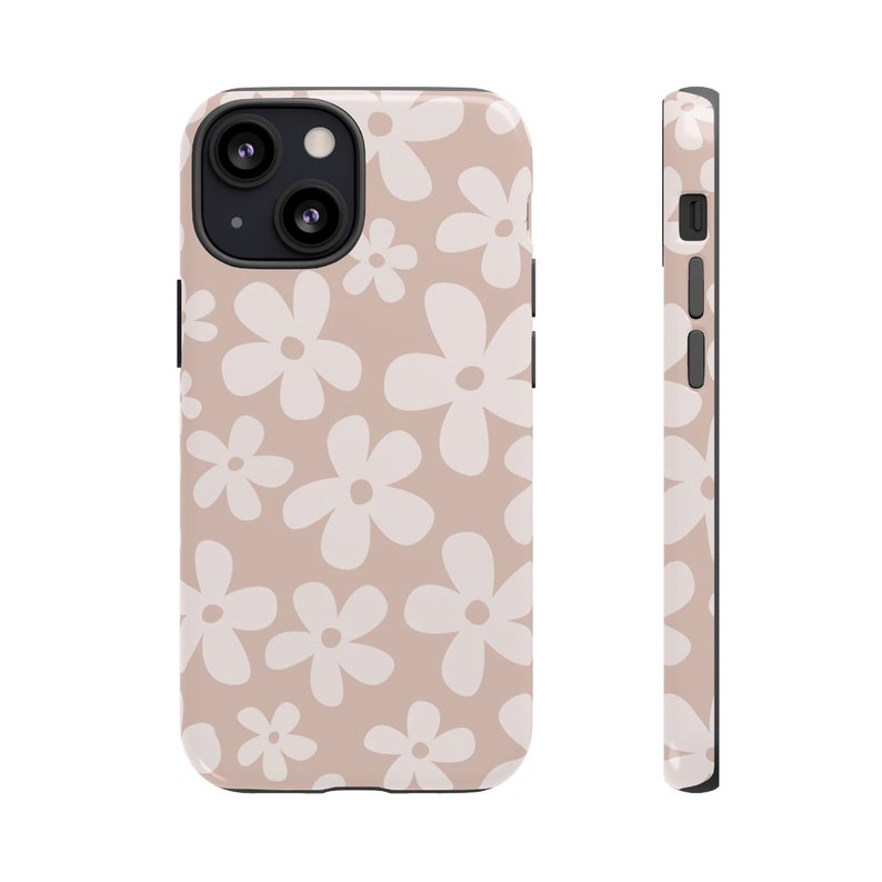 May include: A pink phone case with a white daisy pattern. The case has a black border and a cutout for the camera lens.