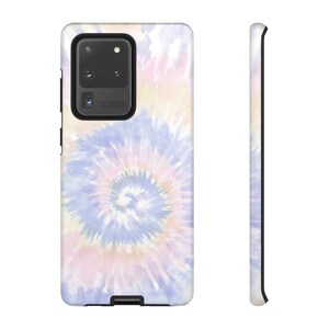 May include: A phone case with a tie-dye pattern in shades of pink, blue, and yellow. The case has a black border and a cutout for the camera lens.