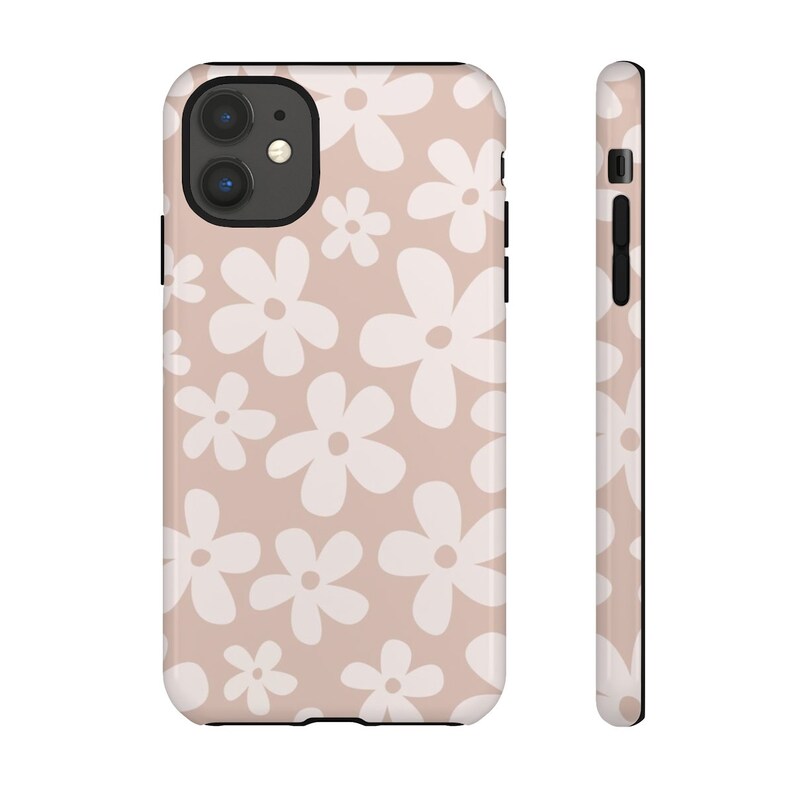 May include: A pink phone case with a white daisy pattern. The case has a black border and a cutout for the camera lens.