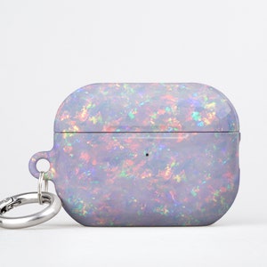 May include: A light purple Airpods case with a sparkly iridescent opal design and a silver carabiner clip.