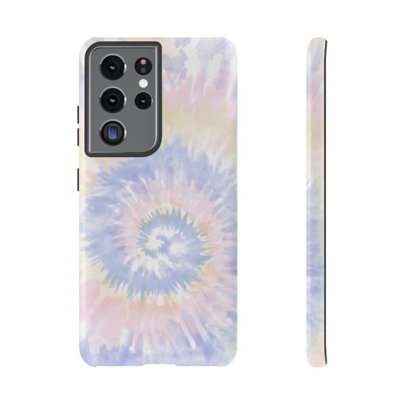 May include: A phone case with a tie-dye pattern in shades of pink, blue, and yellow. The case has a black camera cutout.