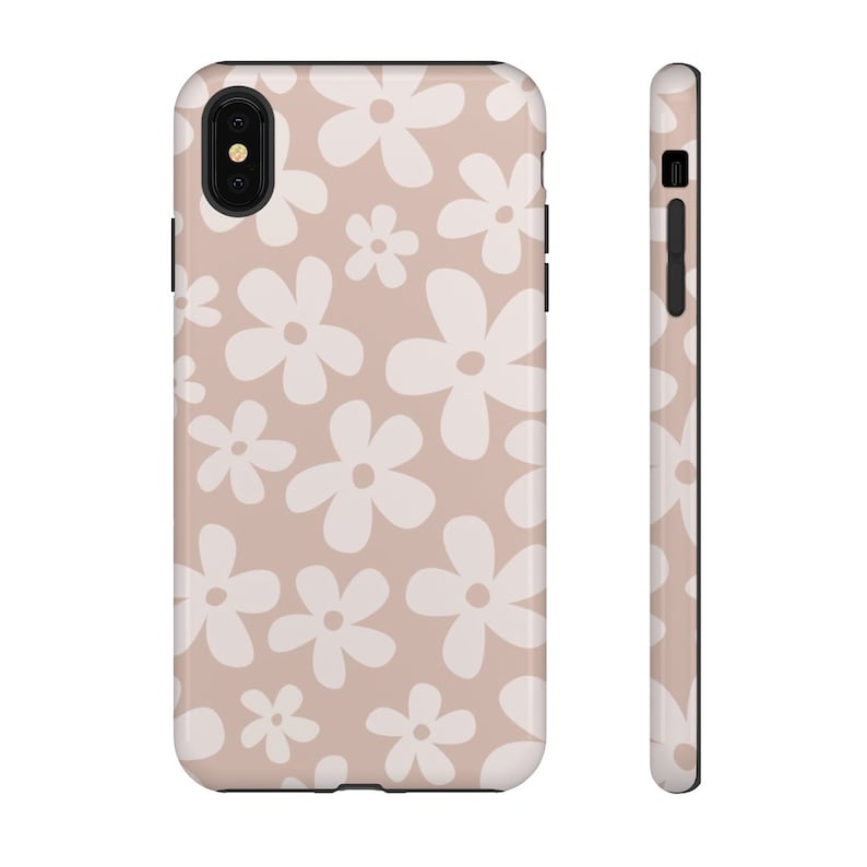 May include: A phone case with a pink background and a white daisy pattern.