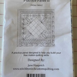 May include: A black and white quilting practice panel with a square design and intricate borders. The panel is labeled "Free Motion Quilting Practice Panel II (White Fabric)". It includes the text "Designed By: Jane Hauprich" and the website "www.stitchbystitchcustomquilting.com".