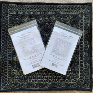 May include: Two white envelopes with black text and a black and white line drawing of a quilt block. The text on the envelopes reads "Free Motion Quilting Practice Panel II" and "Designed By: Jane Hauprich".