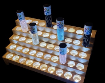 An illuminated display rack for your Essential Oil. Holds 50 Rollon bottles. Select a hole width.