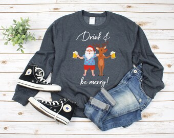 May include: A dark gray sweatshirt with a white graphic of Santa Claus and a reindeer holding beers and the text "Drink & be merry!"