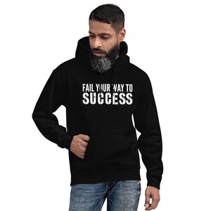 May include: Black hooded sweatshirt with the text "Fail your way to success" in white lettering.