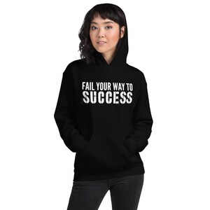 May include: Black hooded sweatshirt with the text "Fail your way to success" in white.