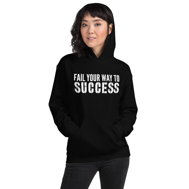 May include: Black hooded sweatshirt with the text "Fail your way to success" in white.