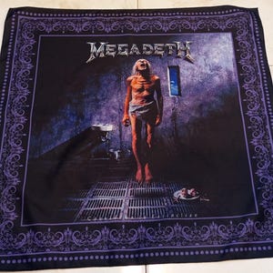 May include: Black square bandana featuring the Megadeth album cover, "Countdown to Extinction." The design includes a gaunt figure in a cell, the band's logo, and a decorative purple border.
