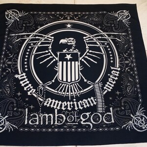 May include: Black bandana with a white graphic featuring an eagle, shield, and the text "pure american metal" and "Lamb of God". The design is framed by a paisley border.
