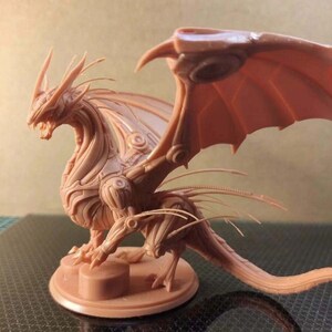 May include: A detailed, beige, plastic miniature of a dragon with articulated wings and a long tail. The dragon is posed in a standing position with its wings spread out.