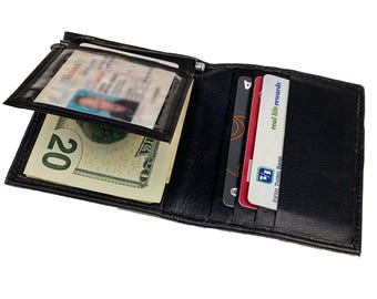 May include: Black leather wallet with a money clip, a clear ID window, and multiple card slots. The wallet is open and contains cash and credit cards, including a Fifth Third Bank card and a real life rewards card.