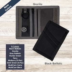 May include: A granite-colored bi-fold wallet with a black mesh interior, a zippered pocket, and a black key ring. A second black ballistic nylon wallet is shown closed. Text includes New Colors, Granite, Black Ballistic, and a list of 9 colors.