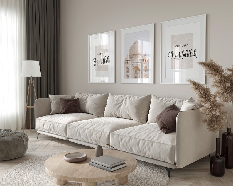 May include: A white couch with brown pillows in a living room with three framed prints on the wall. The prints feature a mosque, the text "start with Bismillah", and the text "end with Alhamdulillah".