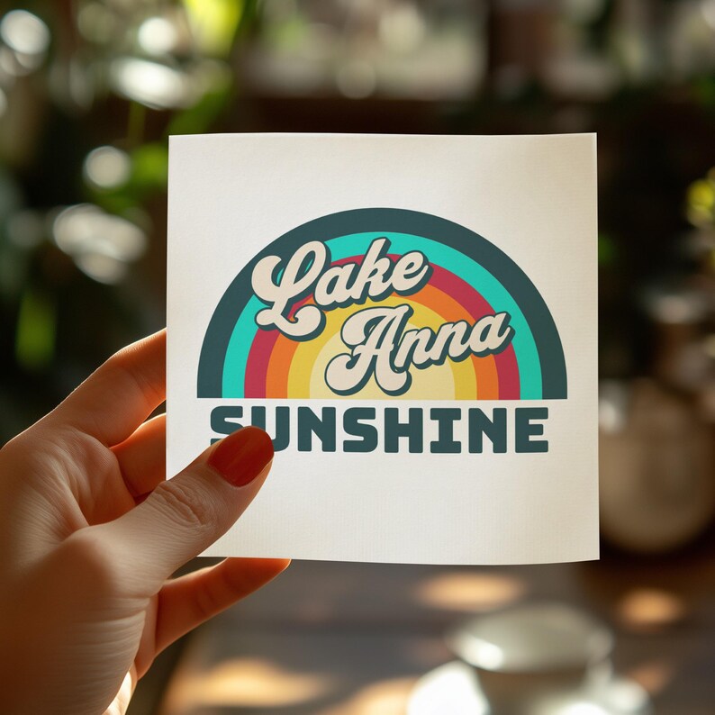 Lake Anna Sunshine logo with rainbow stripes held by a hand.