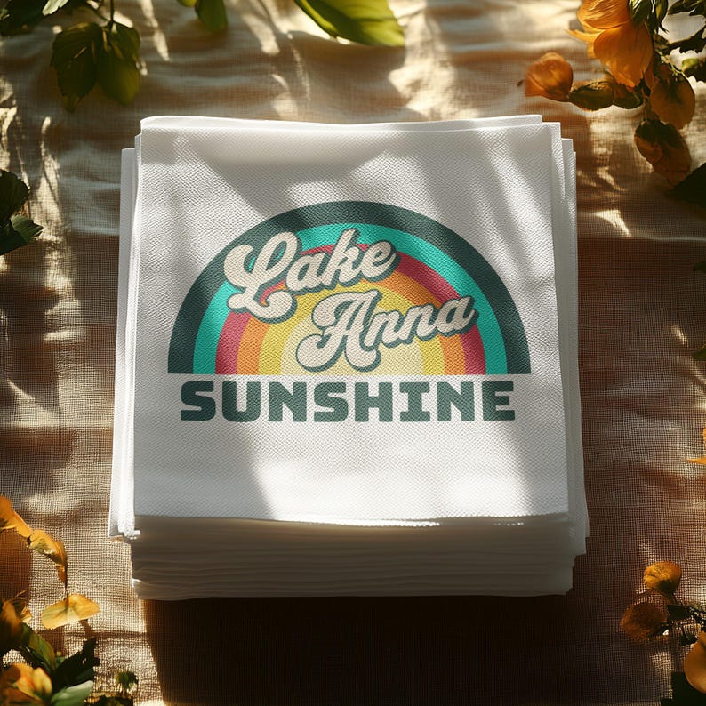 Stack of white napkins with "Lake Anna Sunshine" text in a rainbow arc.