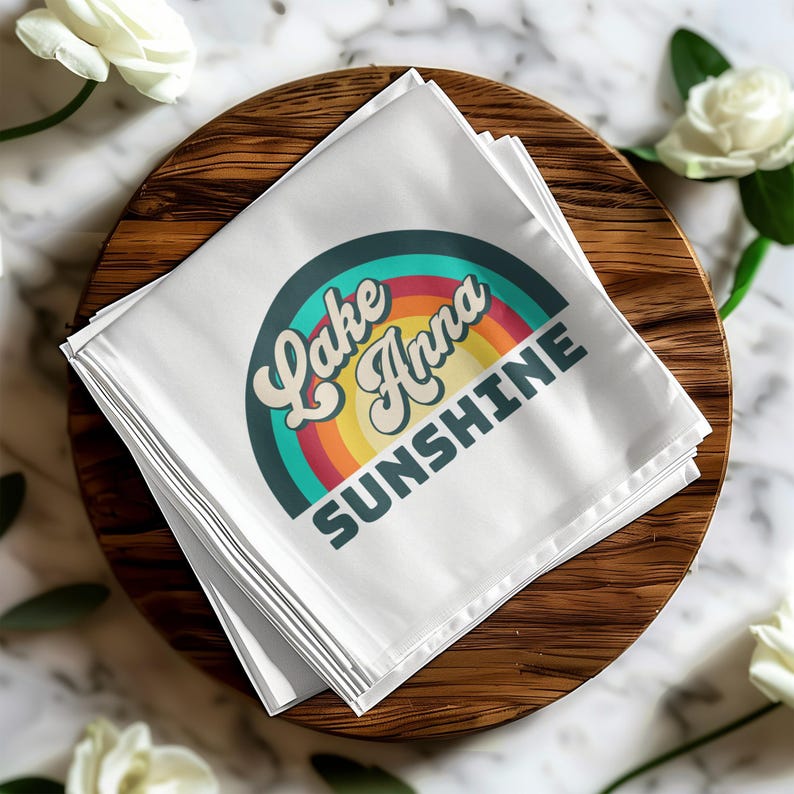 White napkin with "Lake Anna Sunshine" text and rainbow design.