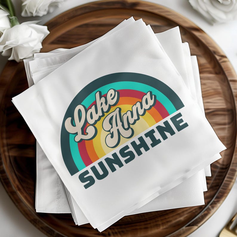 White cocktail napkins with "Lake Anna Sunshine" text and rainbow logo.