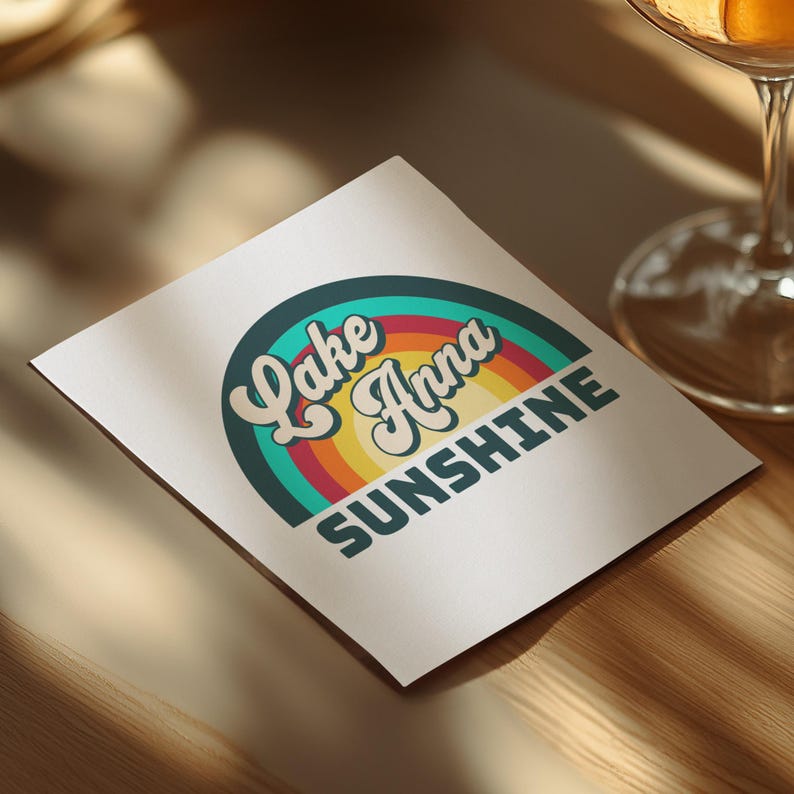 Lake Anna Sunshine text on a coaster with retro rainbow design.