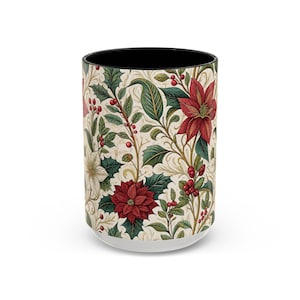 May include: A white ceramic mug with a black interior, featuring a repeating pattern of red poinsettias, green holly leaves, and red berries on a cream background. The mug has a white base.
