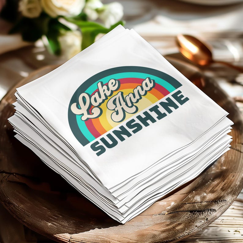 Stack of white napkins with "Lake Anna Sunshine" text and rainbow graphic.