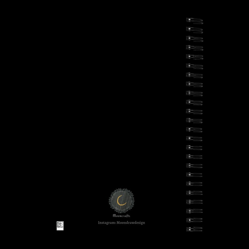 May include: Black and white image of a spiral bound notebook with a black and white logo on the bottom right corner. The logo features a crescent moon with a gold outline and the text "Mooncrafts" below it. The text "Instagram: Moondrawdesign" is below the logo.