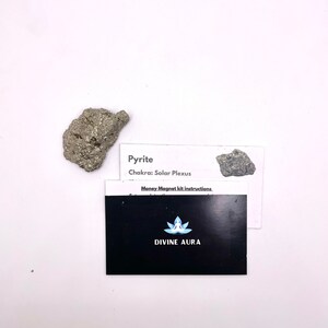 May include: A small, rough, gray and silver pyrite crystal with a white card that reads "Pyrite Chakra: Solar Plexus Money Magnet kit instructions. DIVINE AURA".