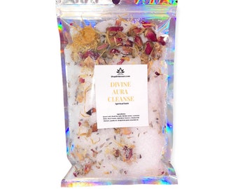 May include: A clear plastic bag filled with white bath salts, dried flowers, and herbs. The bag has a label that reads "Divine Aura Cleanse Spiritual Bath".