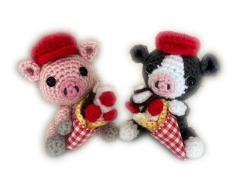 May include: Two crocheted stuffed animals, a pig and a cow, wearing red hats and holding ice cream cones.