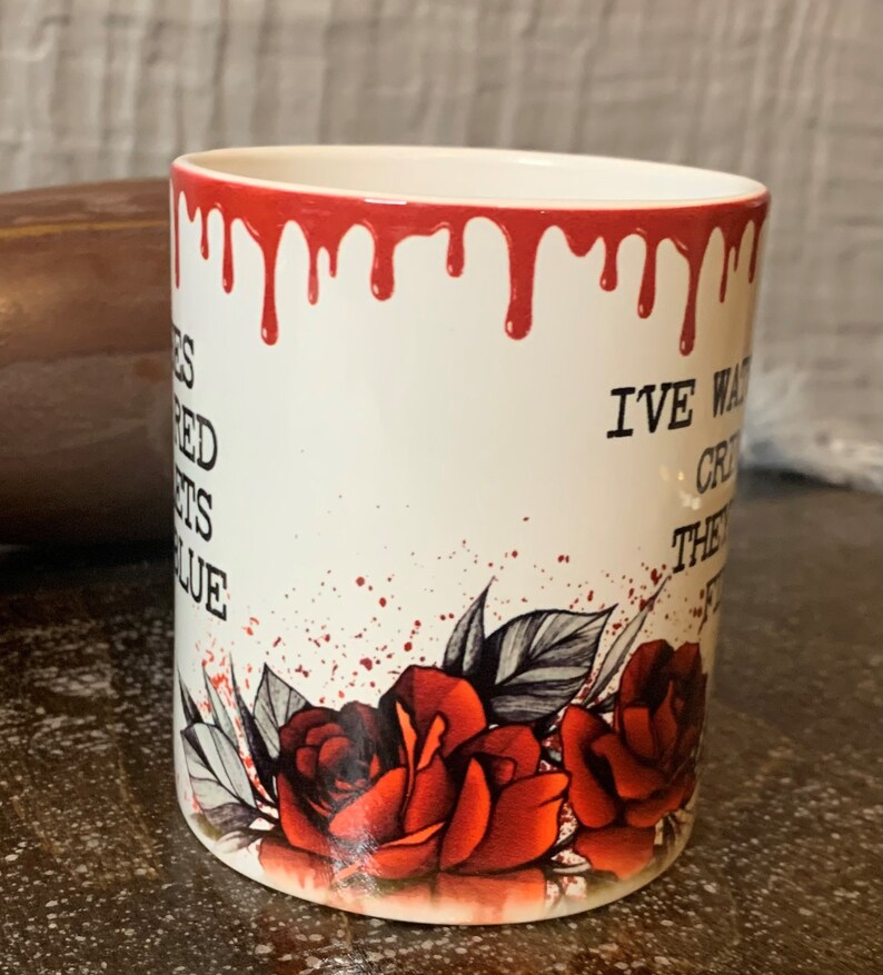 May include: White ceramic mug with red dripping paint around the rim. The mug has a black and white illustration of roses and leaves with red splatter paint. The text "I've waited for this moment my entire life" is printed on the mug.
