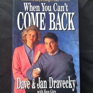 May include: A book cover with the title "When You Can't Come Back" featuring Dave & Jan Dravecky. The cover has a blue background with the title in large white letters. The authors are pictured on the cover.