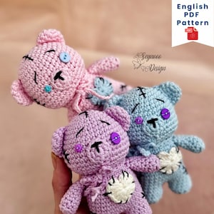 May include: Three crocheted teddy bears in pink, purple, and blue with mismatched buttons for eyes. The bears have stitched-on hearts and are slightly distressed, giving them a vintage look.