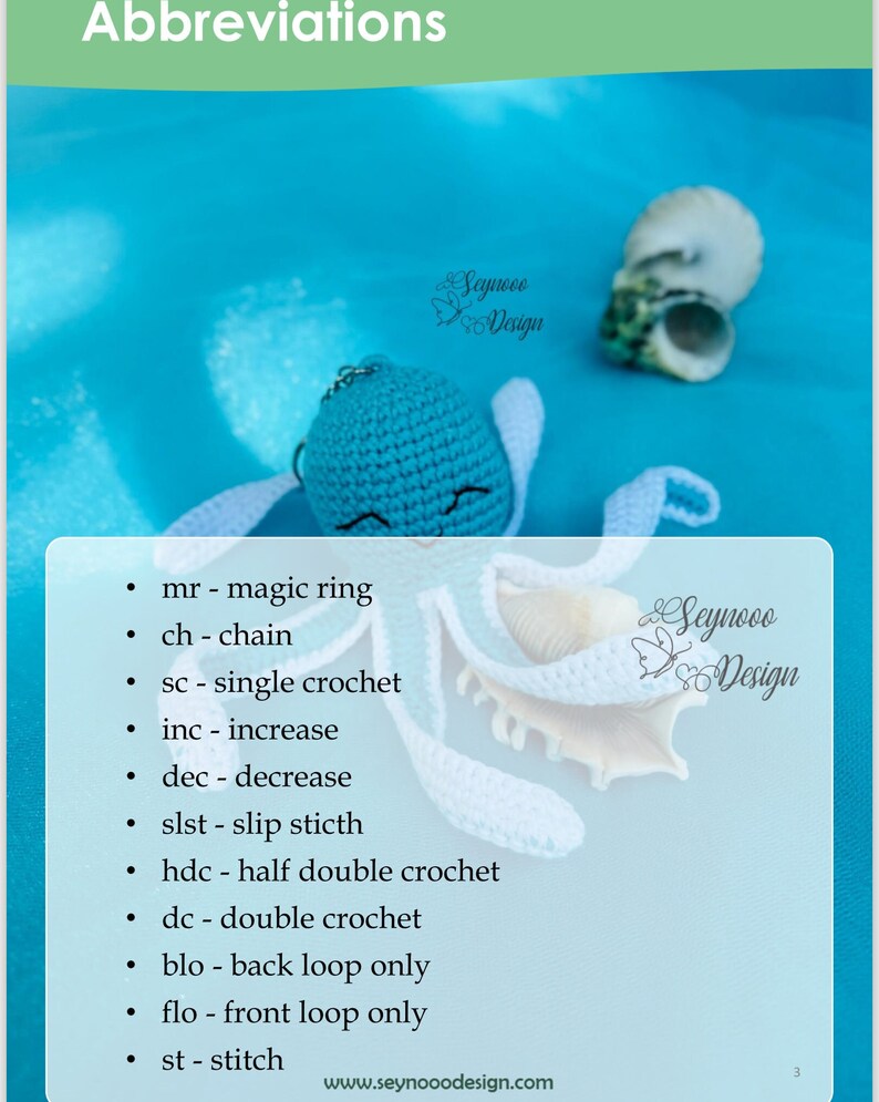 Pu&ograve; includere: Un giocattolo amigurumi in crochet blu con un viso sorridente e ali in crochet bianco. Il giocattolo &egrave; seduto su una superficie blu con due conchiglie bianche. L'immagine include un elenco di abbreviazioni di crochet, tra cui mr, ch, sc, inc, dec, slst, hdc, dc, blo, flo e st. Il testo "Seynooo Design" appare due volte nell'immagine.