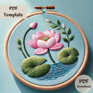 May include: A PDF embroidery pattern for a pink lotus flower with green leaves and blue water. The pattern is displayed in a wooden embroidery hoop.