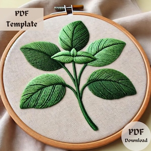 May include: A green embroidery pattern of a leafy plant branch on a beige fabric background in a wooden embroidery hoop. The text "PDF Template" and "PDF Download" are visible in the image.
