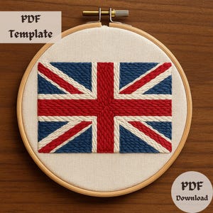 Può includere: Un telaio da ricamo con un disegno a bandiera Union Jack ricamato. La bandiera è realizzata con fili blu, rossi e bianchi su un tessuto color crema. Sono visibili anche i testi "PDF Template" e "PDF Download".